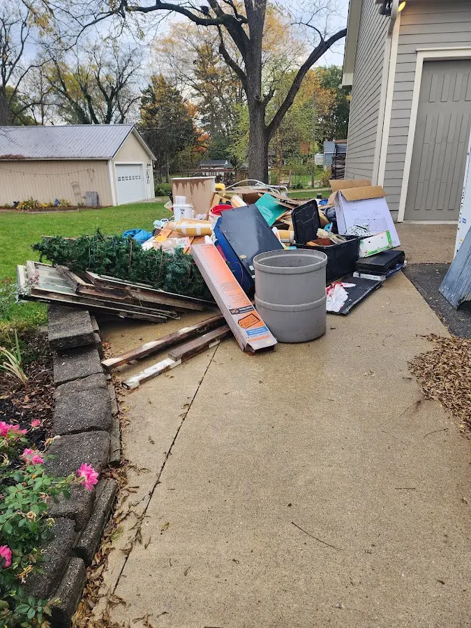 Dumpster being loaded with debris for Estate Cleanout Dumpster Rental in Smyrna
